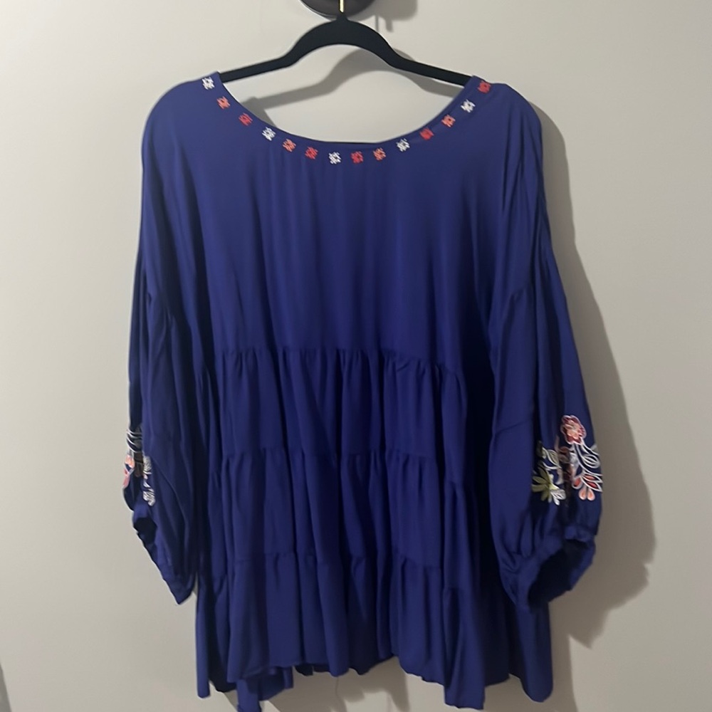 Blue flows top with stitched embroidered flowers.